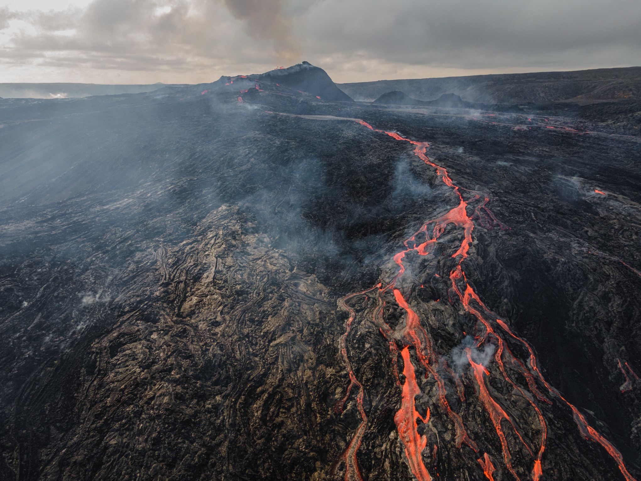 Lava flow from the Fagradalsfjall volcanic eruption and view of the crator